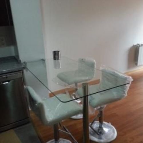mesa de cristal con pata en inox y soporte a pared